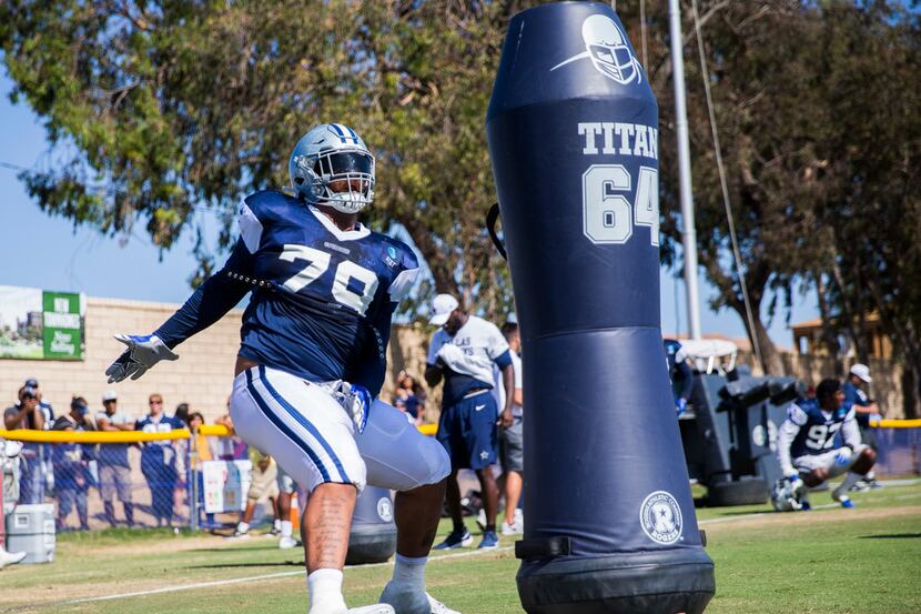 Dallas Cowboys defensive tackle Trysten Hill (79) attacks a dummy during an afternoon...