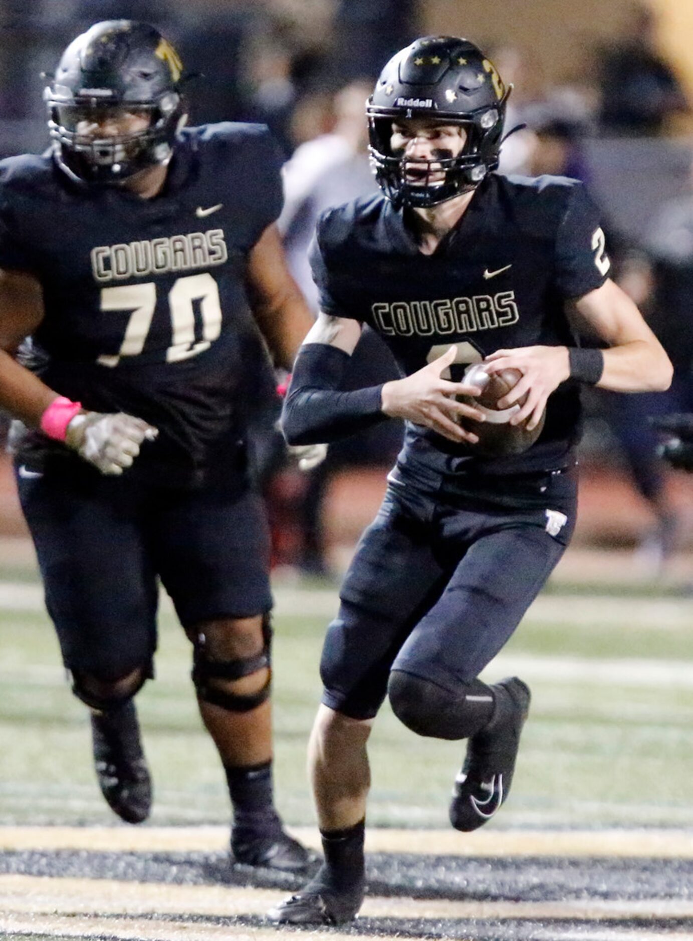 The Colony High School quarterback Kenneth Harrington (2) runs with the ball during the...