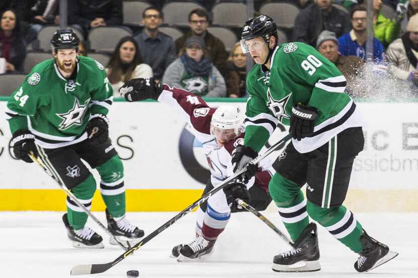 Colorado Avalanche defenseman Tyson Barrie (4) tries to steal the puck from Dallas Stars...