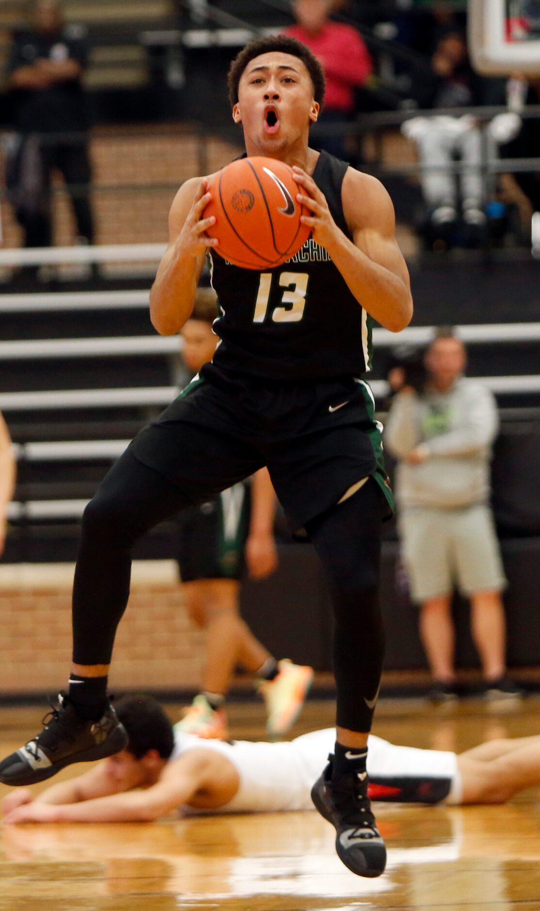 Waxahachie guard Preston Hodge (13) reacts in disbelief after being whistled for a foul...