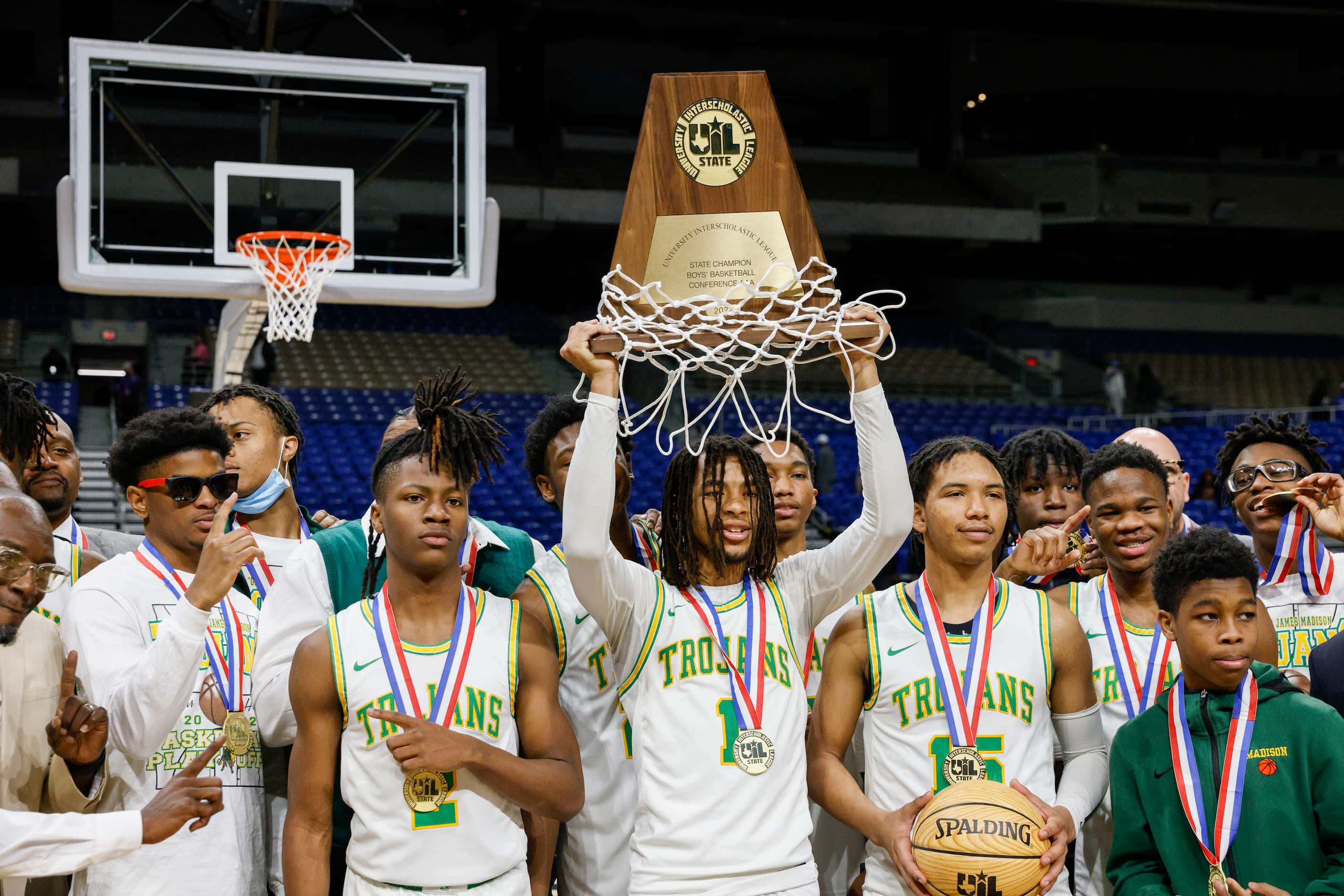 Madison guard Pierre Hunter (1) raises the Class 3A state championship trophy at the...