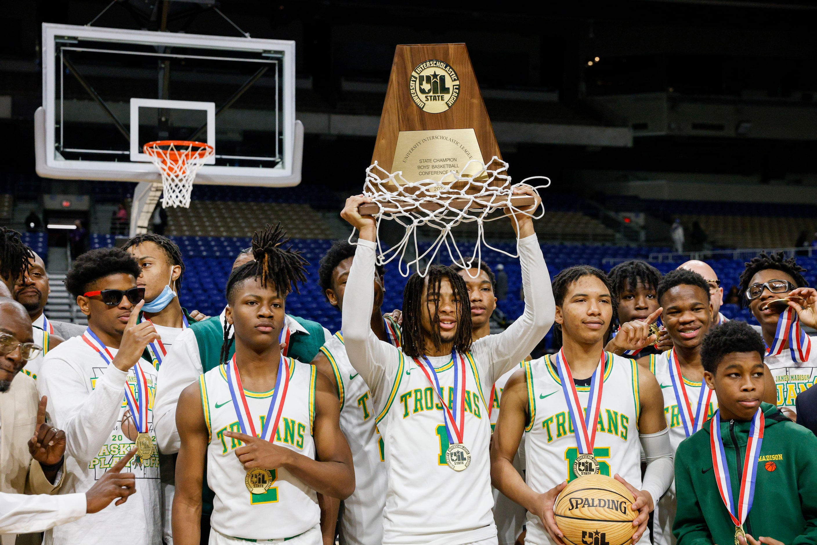 Madison guard Pierre Hunter (1) raises the Class 3A state championship trophy at the...