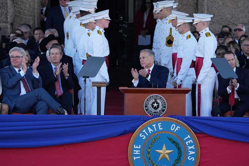 Texas Gov. Greg Abbott, right, and Lt. Gov. Dan Patrick, left, clap during their...