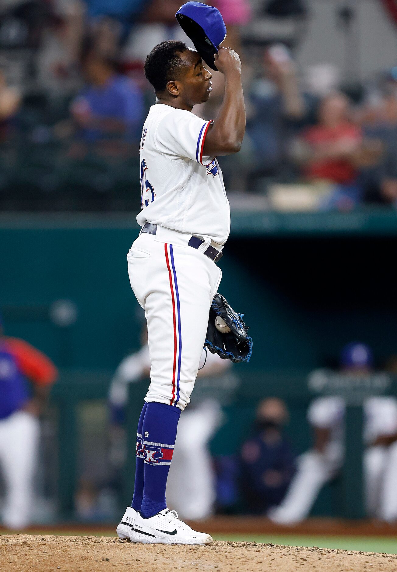 Texas Rangers relief pitcher Jharel Cotton (45) reacts after giving up a home run to Oakland...