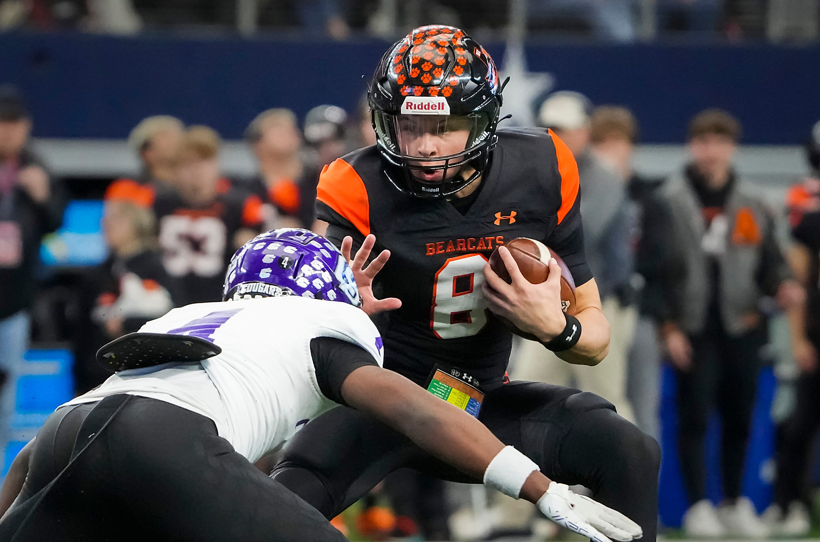 Aledo quarterback Hauss Hejny (8) tries to push past College Station defensive back Tony...