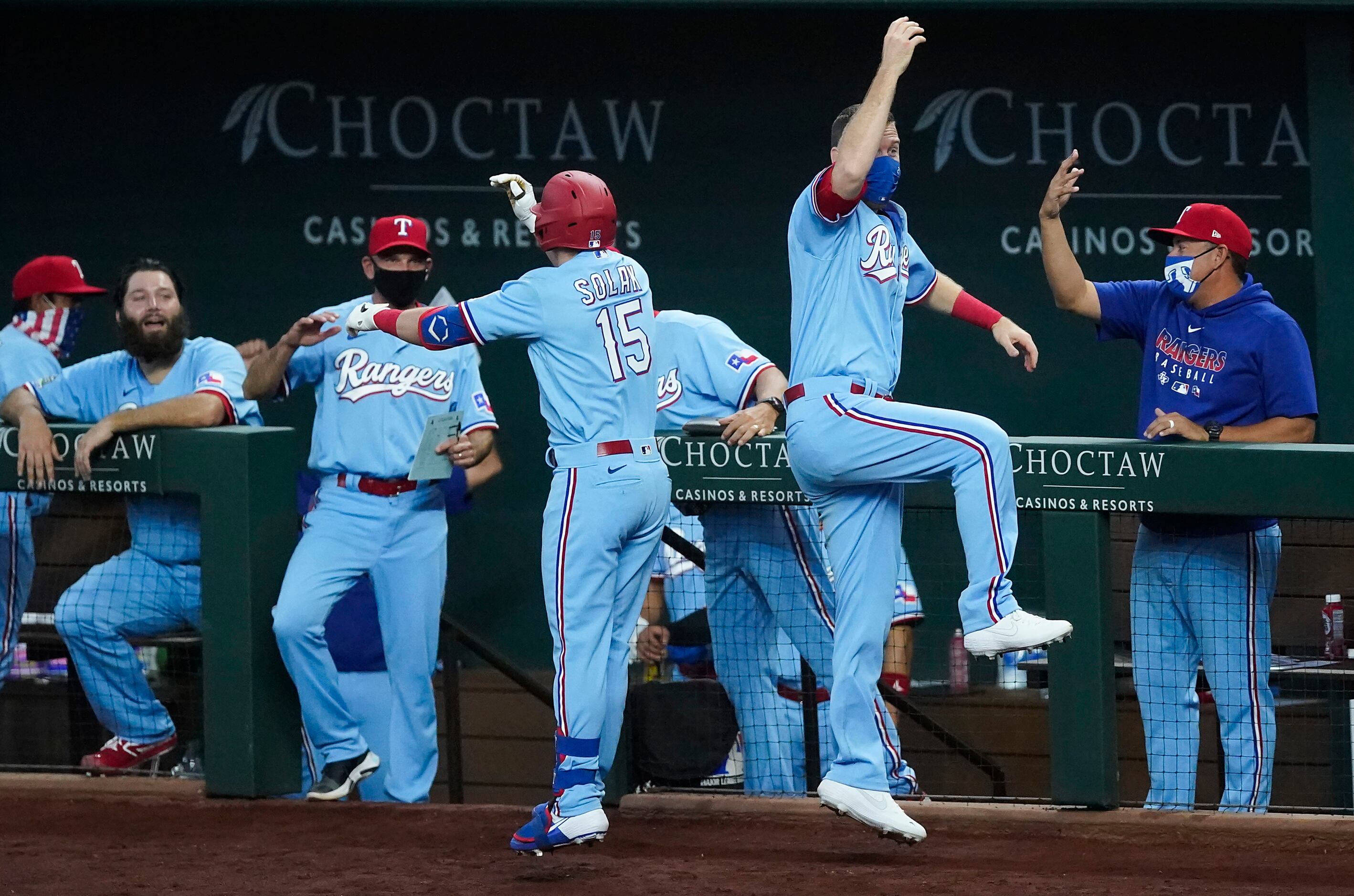 Texas Rangers outfielder Nick Solak celebrates with Todd Frazier as he gets back to the...