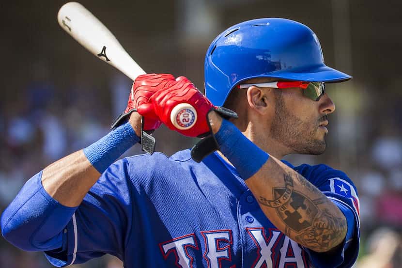 Texas Rangers outfielder Ian Desmond stands in the on deck circle during a spring training...