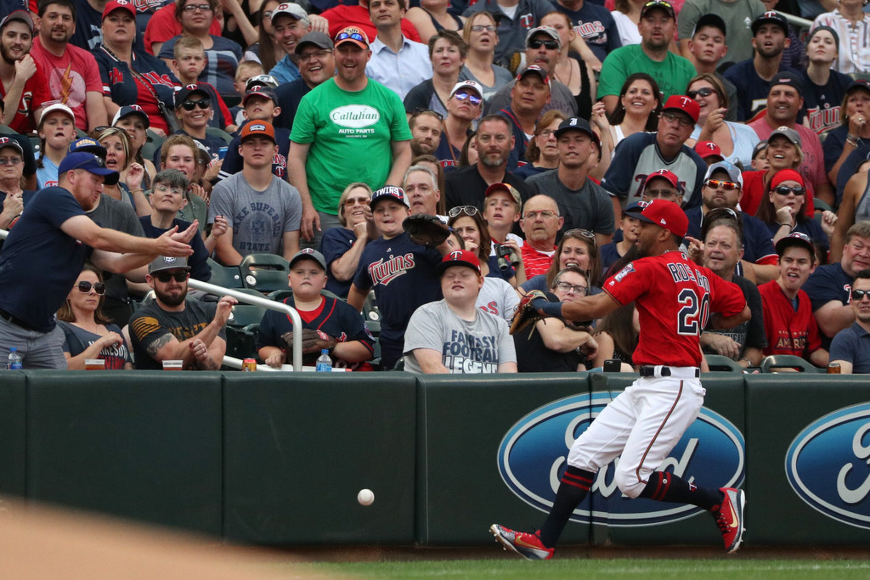 Minnesota Twins left fielder Eddie Rosario (20) chases down a ball hit by the Texas Rangers'...