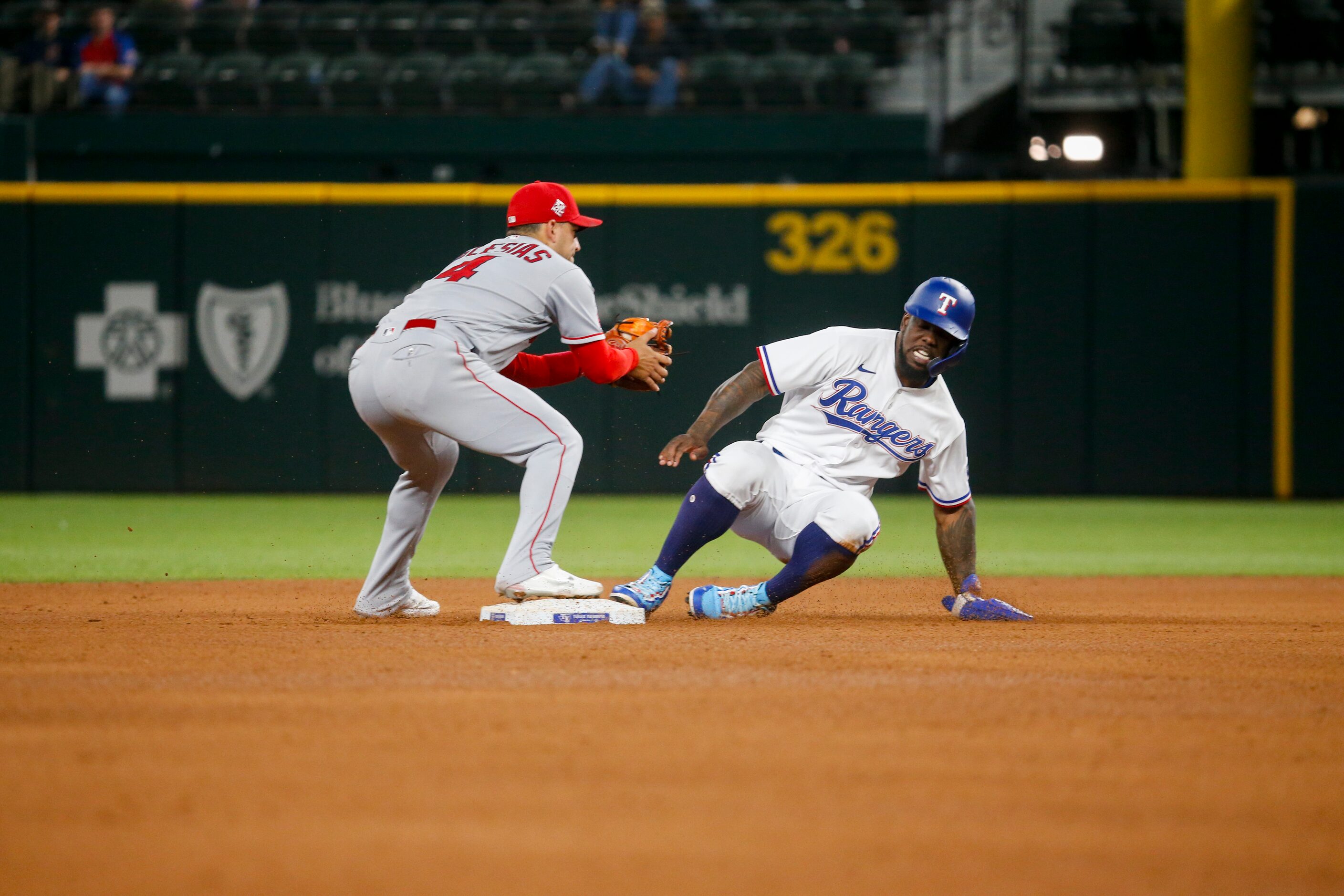 Los Angeles Angels shortstop Jose Iglesias (4) stops Texas Rangers right fielder Adolis...