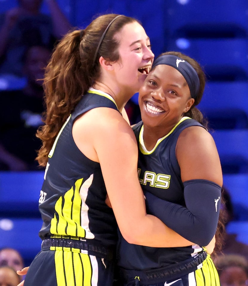 Dallas Wings guard Arike Ogunbowale (24), right, sports a Texas-sized smile after setting a...