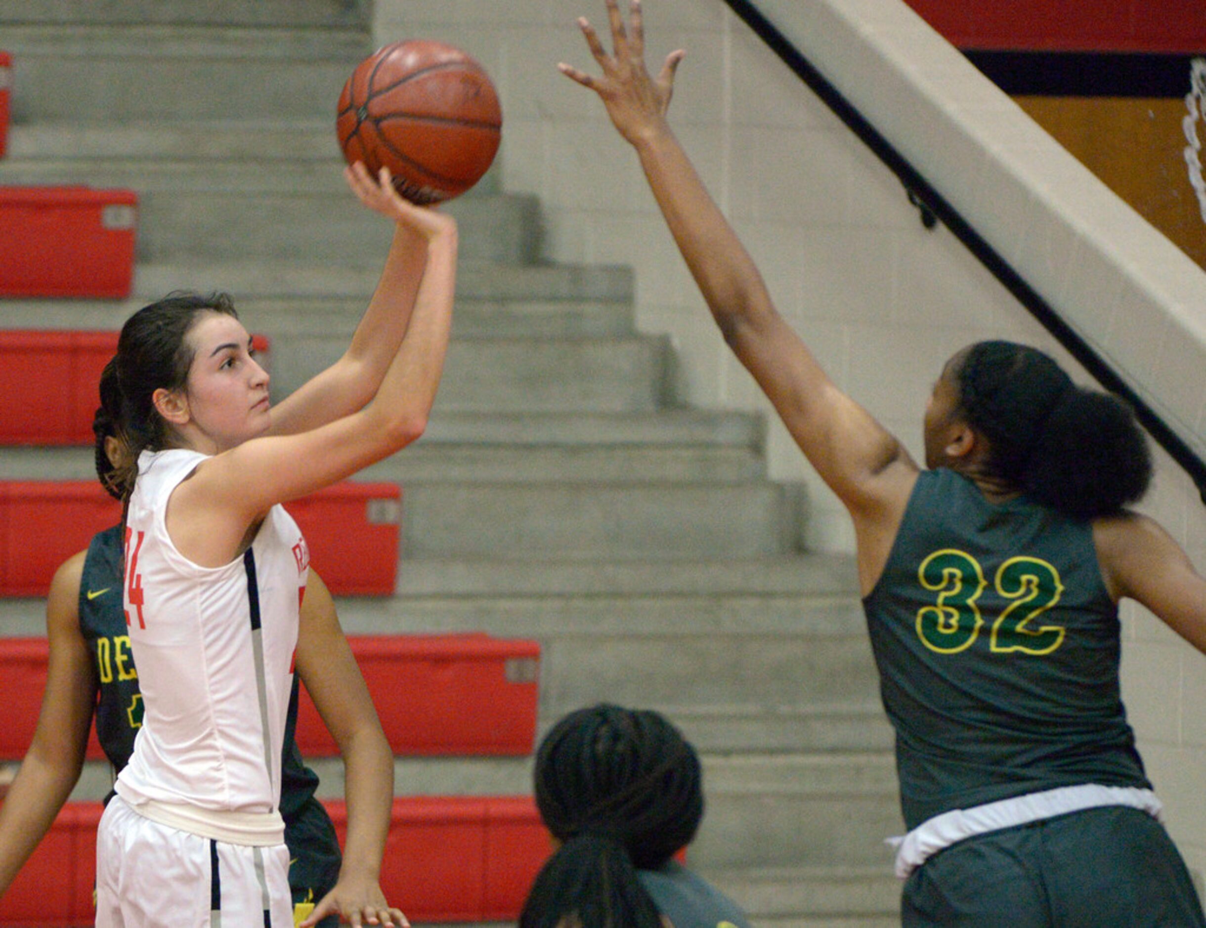 Liberty's Maya Jain shoots over DeSoto's Tionna Herron during a girls high school basketball...