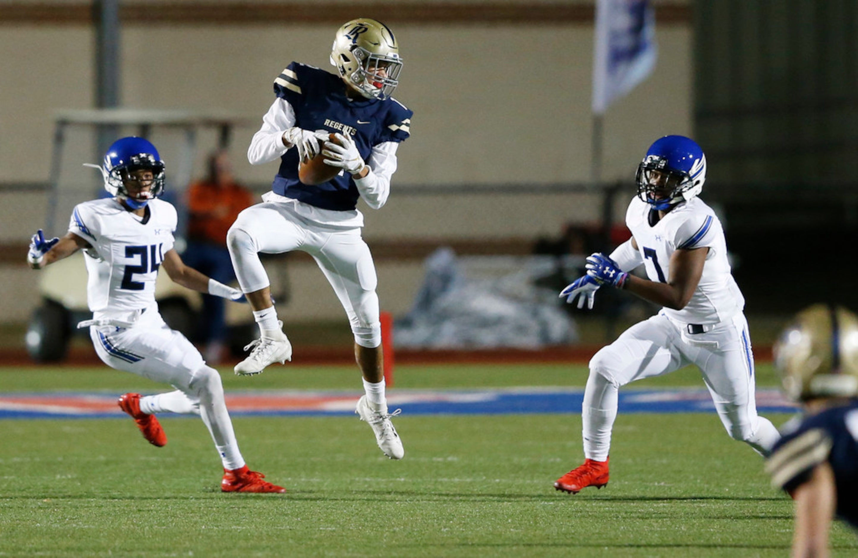 Austin Regents Aidan McCormick (12) catches a pass in between Trinity Christian's Tony...