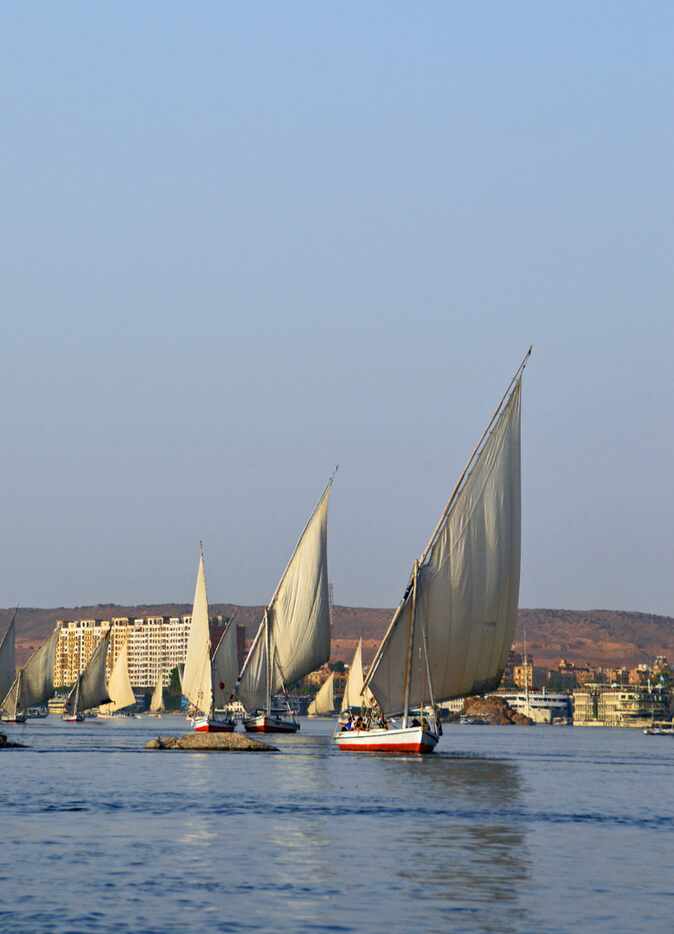 Felucca excursions on the Nile River near Aswan are popular with tourists. 