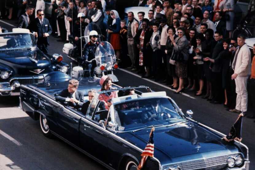 President John F. Kennedy and first lady Jacqueline Kennedy riding through Dallas in the...