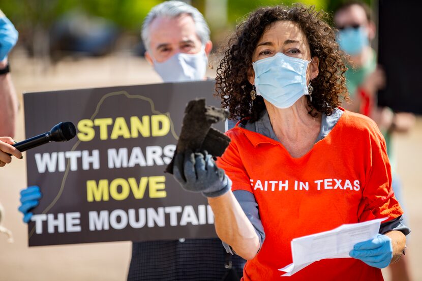 Rabbi Nancy Kasten holds up a few pieces of shingles from “Shingle Mountain” in southeast...