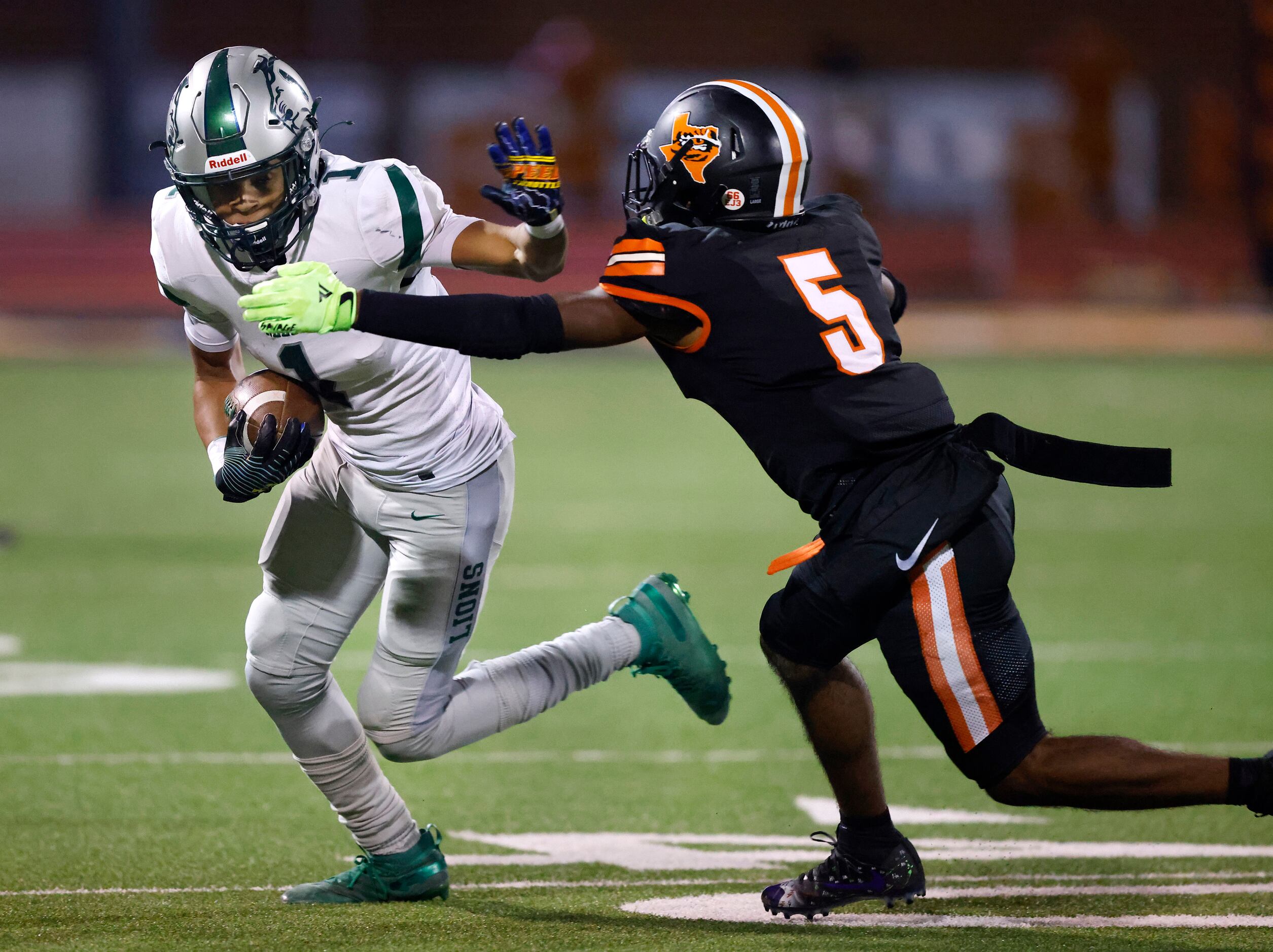 Frisco Reedy wide receiver Kaleb Smith (1) gives a stiff arm to Lancaster defensive back...