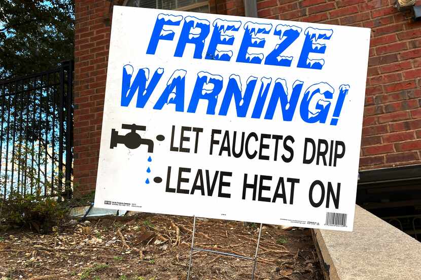 A "Freeze Warning!" sign stands outside of an apartment on Randall St in Uptown in Dallas on...