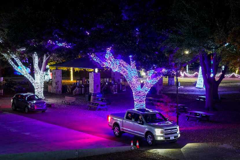 Motorists make their way through displays during Dallas Zoo Lights on Wednesday, Nov. 18,...
