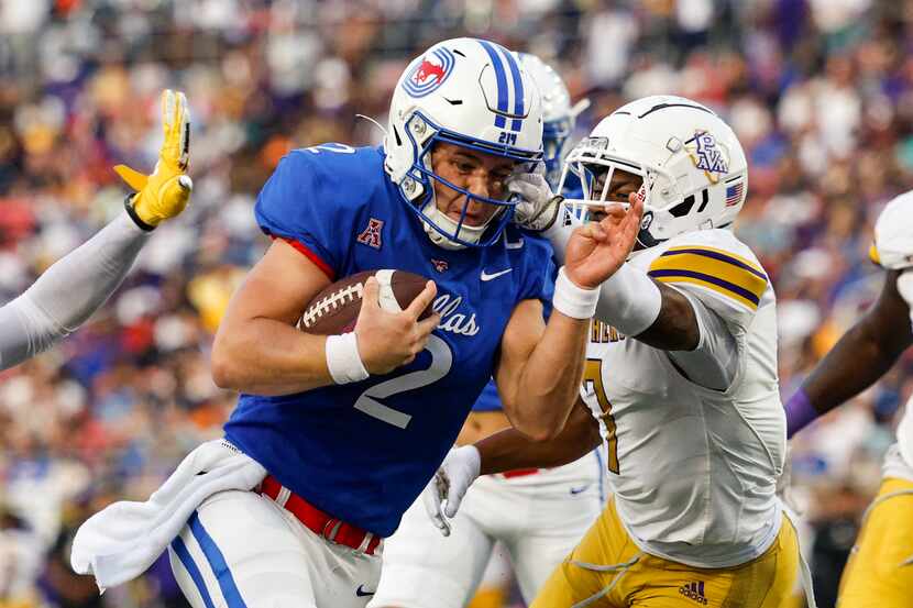 SMU quarterback Preston Stone (2) squeezes through the Prairie View A&M defensive line to...