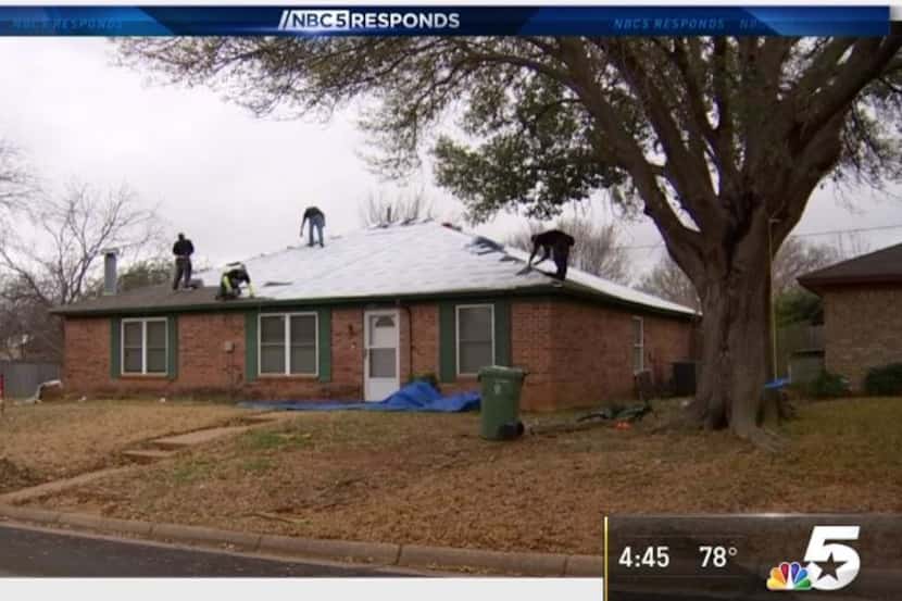 Roofers atop the home of Arlington homeowner Joe Dickens. He was a victim of a giant roofing...