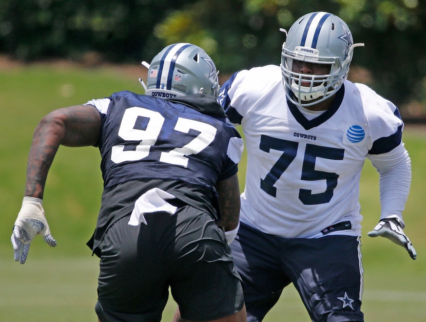 Cowboys offensive tackle Cameron Fleming (75) blocks defensive end Taco Charlton (97) during...