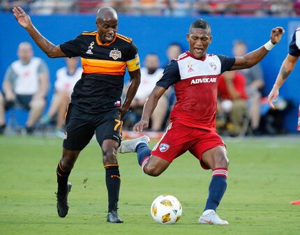 FC Dallas midfielder Carlos Gruezo (7) attempts a shot next to Houston Dynamo midfielder...