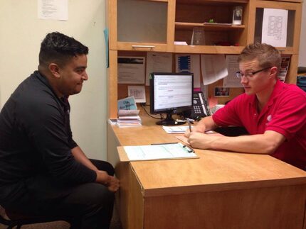 Ricardo Cuevas works with Daniel Adriansen of Catholic Charities to start his citizenship...