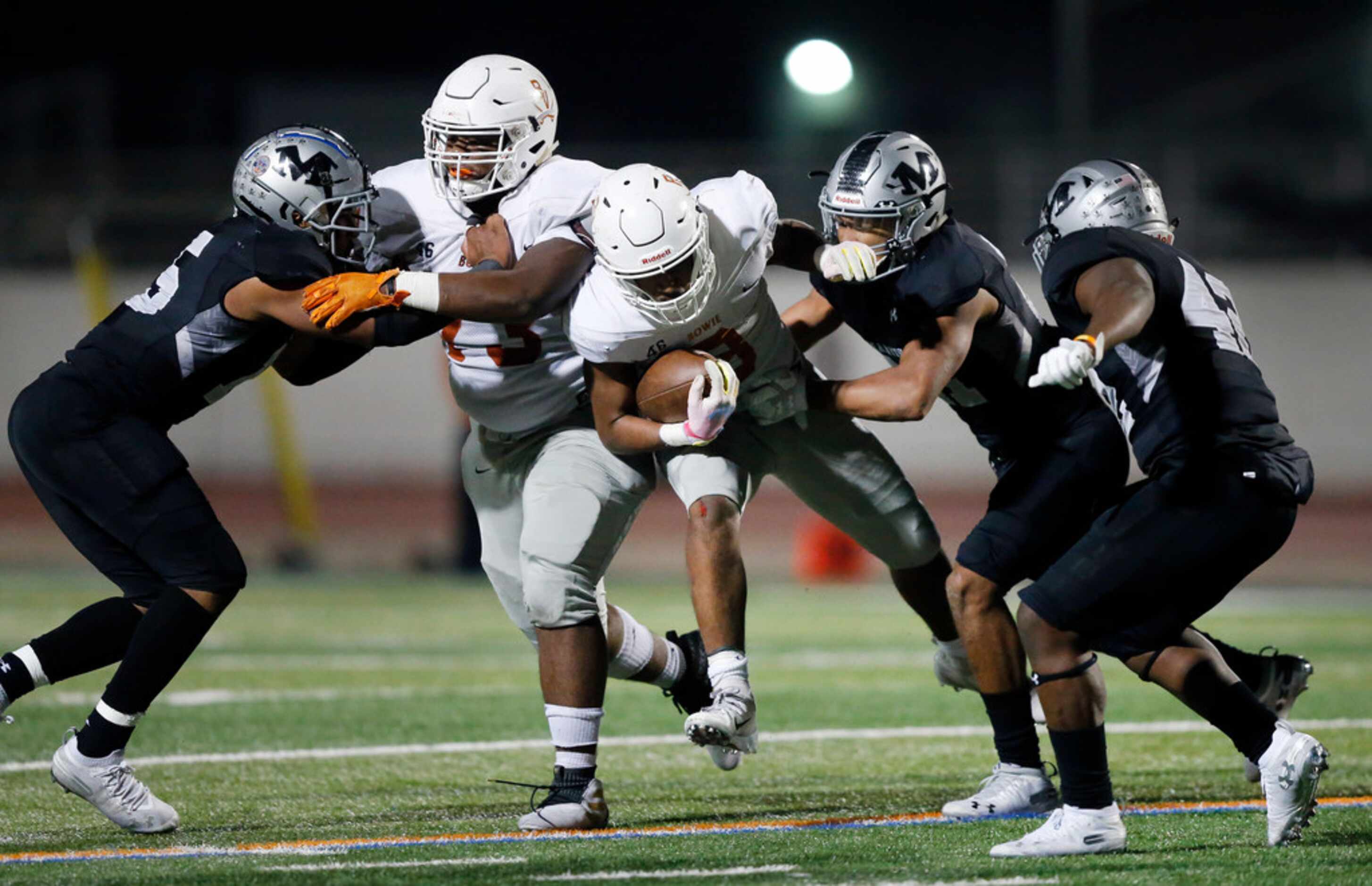 Bowie running back D'Aunte Prevost (3) carries the ball during the second half as he gets a...