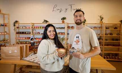 Grecia Alfaro and her partner Marcos Duran pose for a photo at their candle shop, “Luz Y...