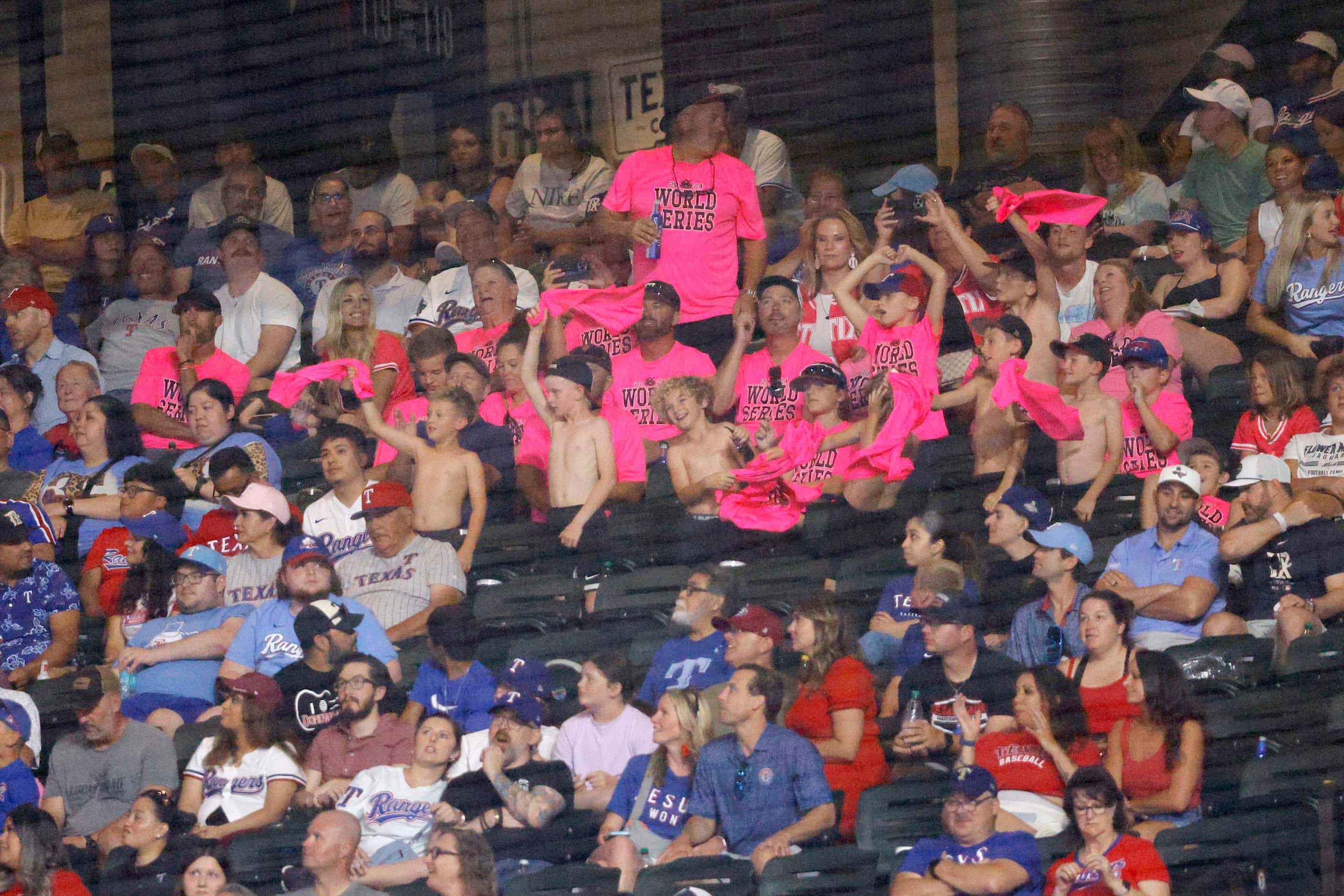 Fans cheer during the eighth inning of a baseball game between the Texas Rangers and the...