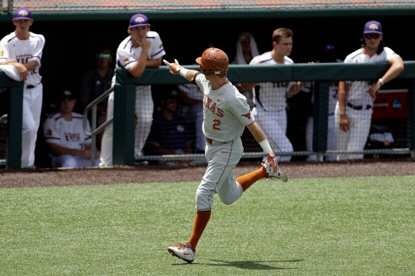 Texas infielder Kody Clemens (2) flashes the hook 'em sign at the Tennessee Tech dugout as...