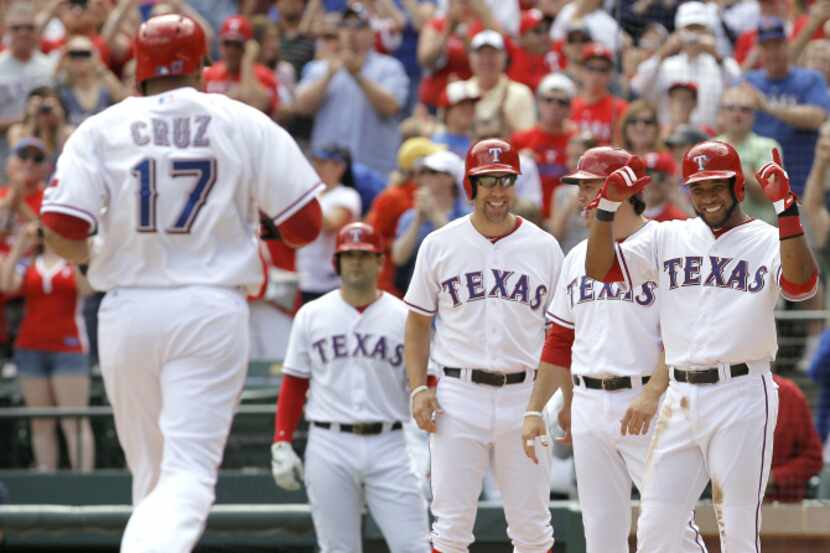 From right: Texas Rangers Elvis Andrus, Lance Berkman  and David Murphy  congratulate...