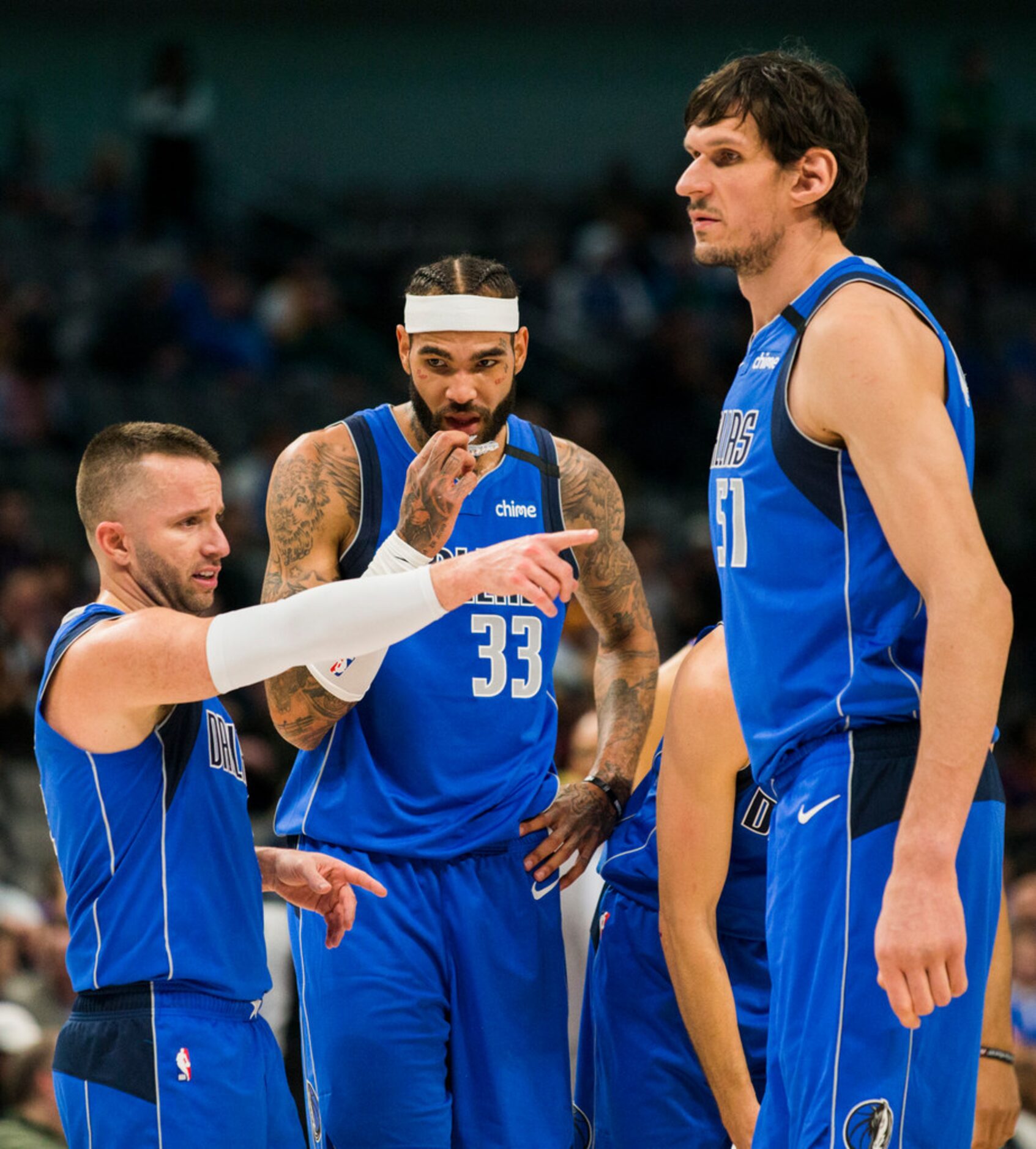 Dallas Mavericks center Willie Cauley-Stein (33) and center Boban Marjanovic (51) listen as...