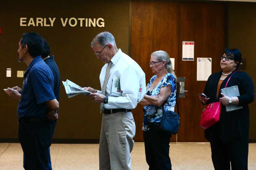 Voters stand in line Monday, Oct. 24, 2016, at the Nueces County Courthouse on the first day...