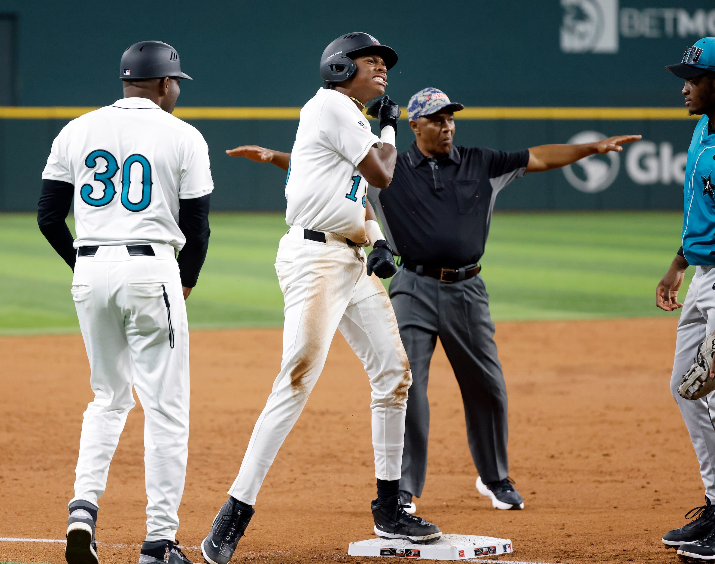 American League batter Robert Tate Jr.(15) reacts after hitting a triple during the third...