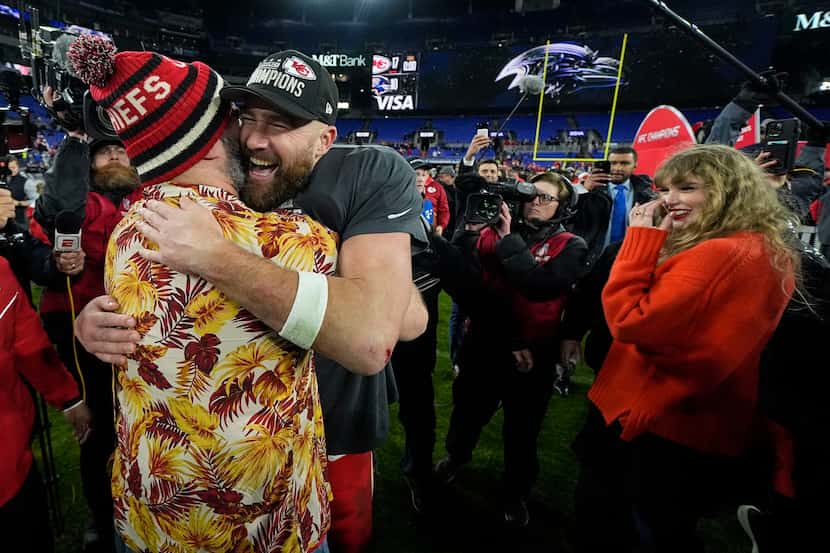 NFL player Jason Kelce, left, embraces his brother Kansas City Chiefs tight end Travis Kelce...