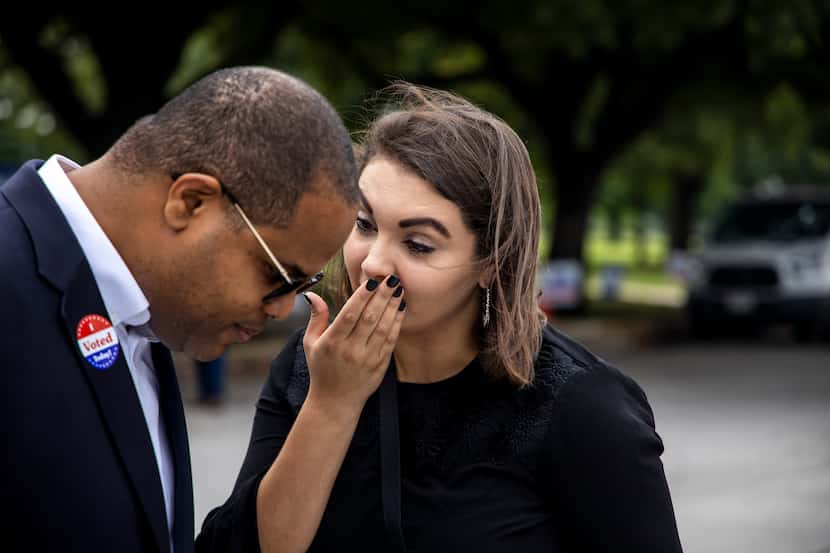  Eric Johnson listens to his campaign manager, Mary Elbanna, after he voted at the Samuell...