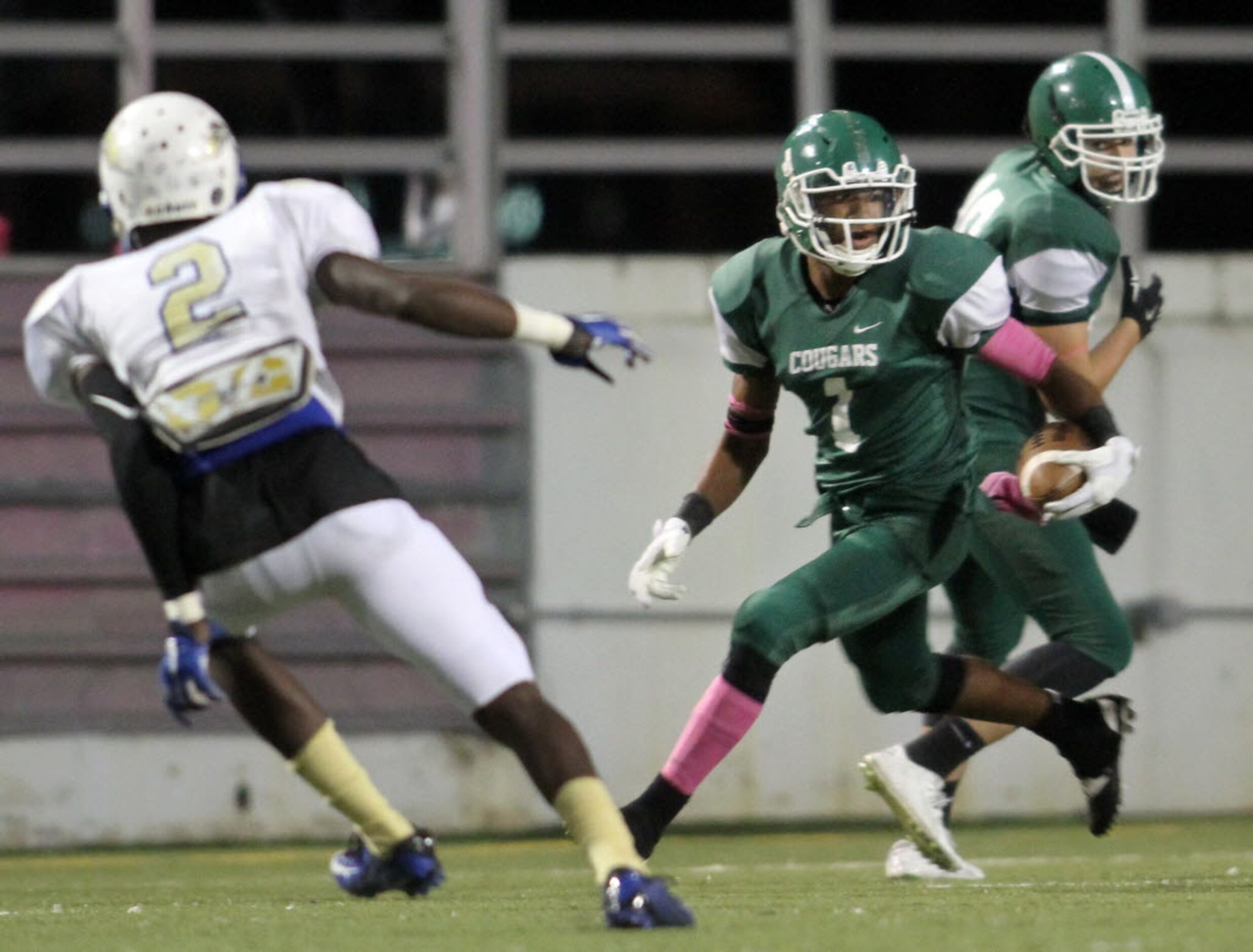 Bryan Adams receiver eyes his blocks as he returns a second quarter punt while Conrad...