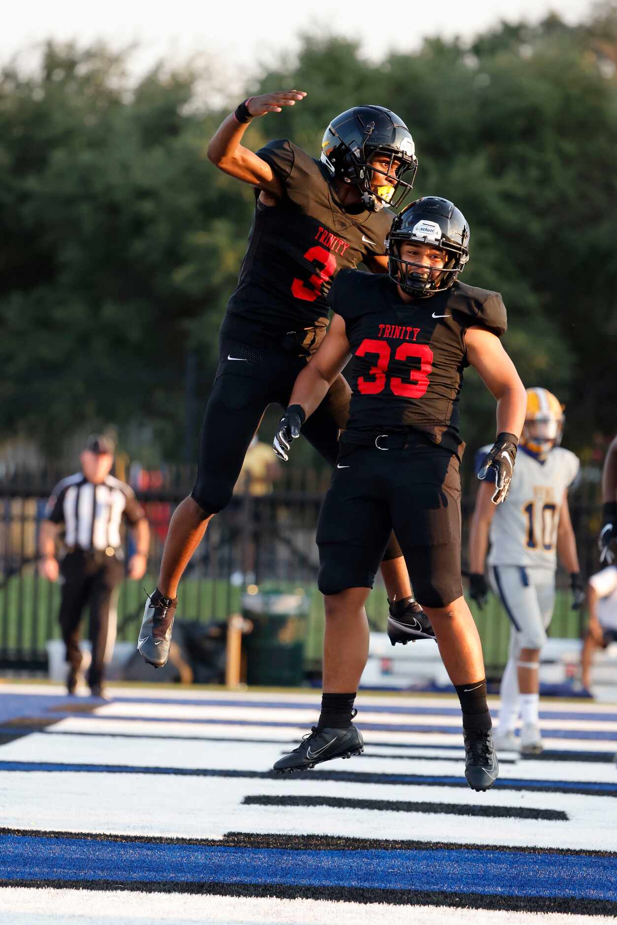 Euless Trinity running back Garry Maddox (3) celebrates his touchdown against Arlington...