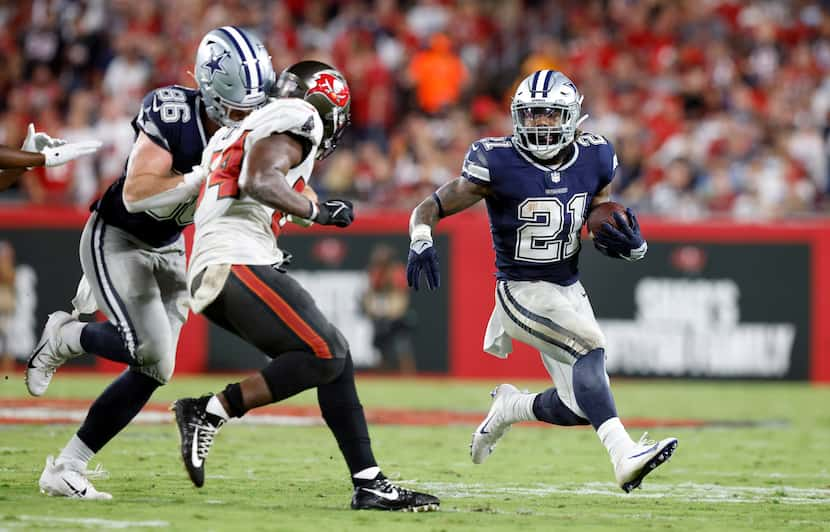 Dallas Cowboys running back Ezekiel Elliott (21) receives a block from tight end Dalton...