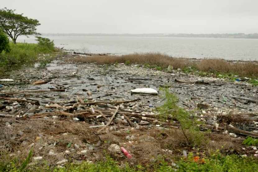 
Trash and debris accumulate along the shore of Lake Ray Hubbard by the Rowlett Road Bridge. 
