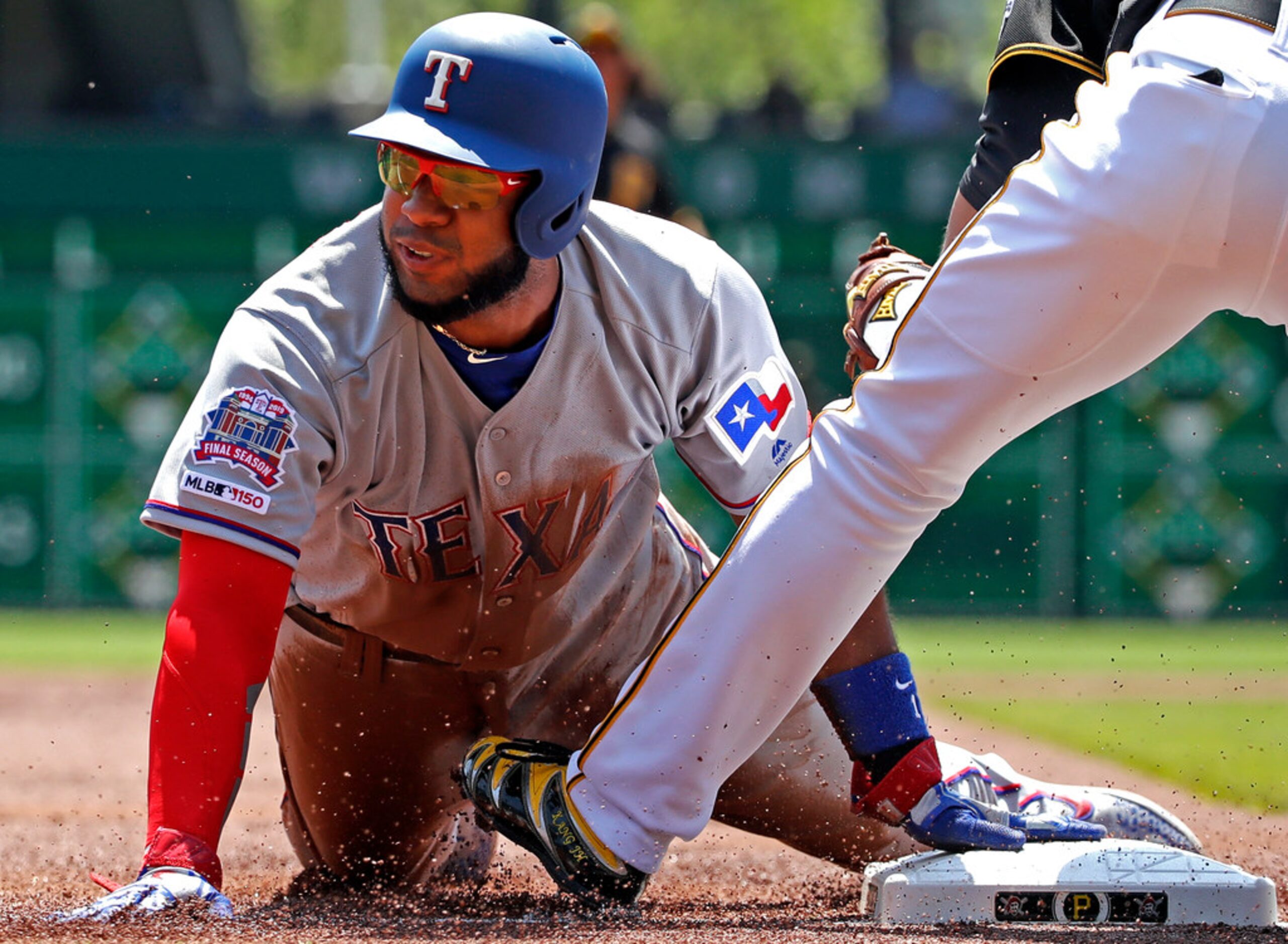 Texas Rangers' Elvis Andrus steals third ahead of the tag by Pittsburgh Pirates third...