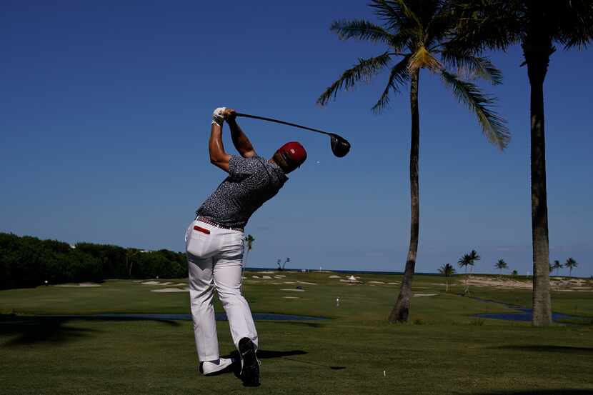 Pierceson Coody, of the USA team, watches his tee shot on the 12th hole in the singles...