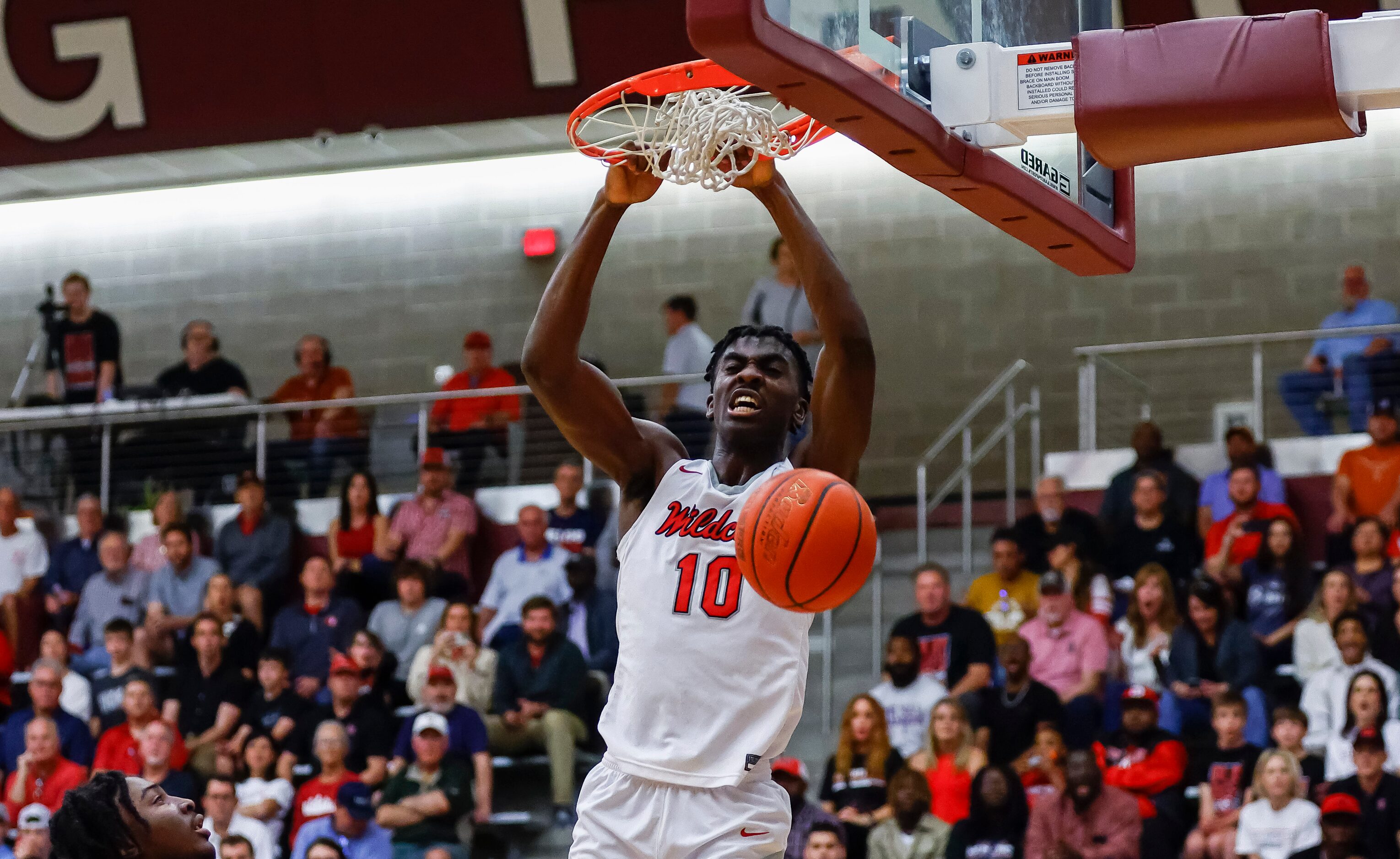 Lake Highlands senior forward Samson Aletan dunks during a Class 6A bi-district playoff game...