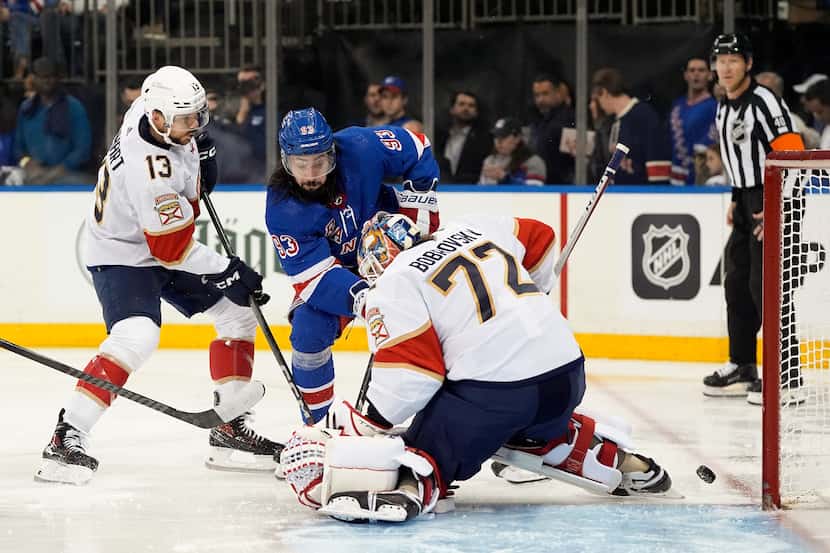Florida Panthers goaltender Sergei Bobrovsky (72) deflects a shot by New York Rangers center...
