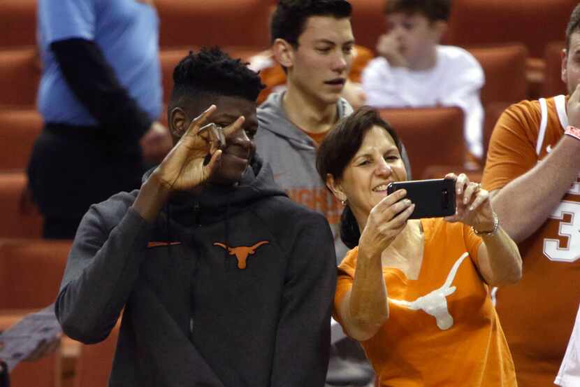 Texas center Mohamed Bamba, left, has his picture taken with a Texas fan before an NCAA...