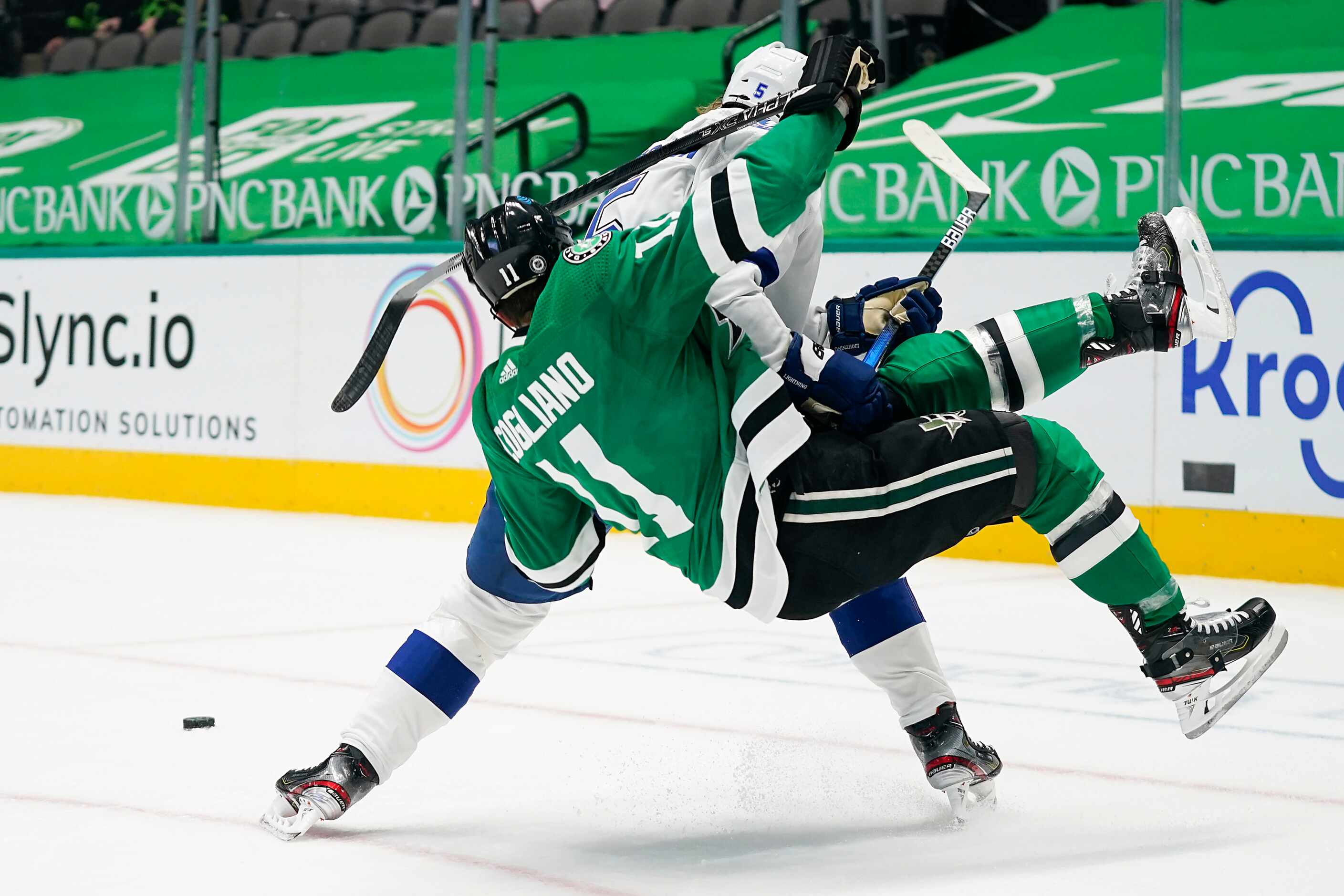 Dallas Stars center Andrew Cogliano (11) is knocked off his skates by Tampa Bay Lightning...