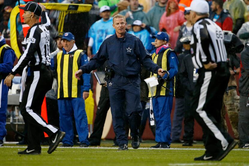 Dallas Cowboys head coach Jason Garrett (center) reacts to a call against his team during...