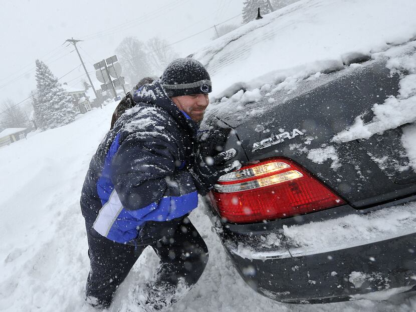  Chad Reams helps a stuck driver along East Market Street in York, Pa. during Saturday's...
