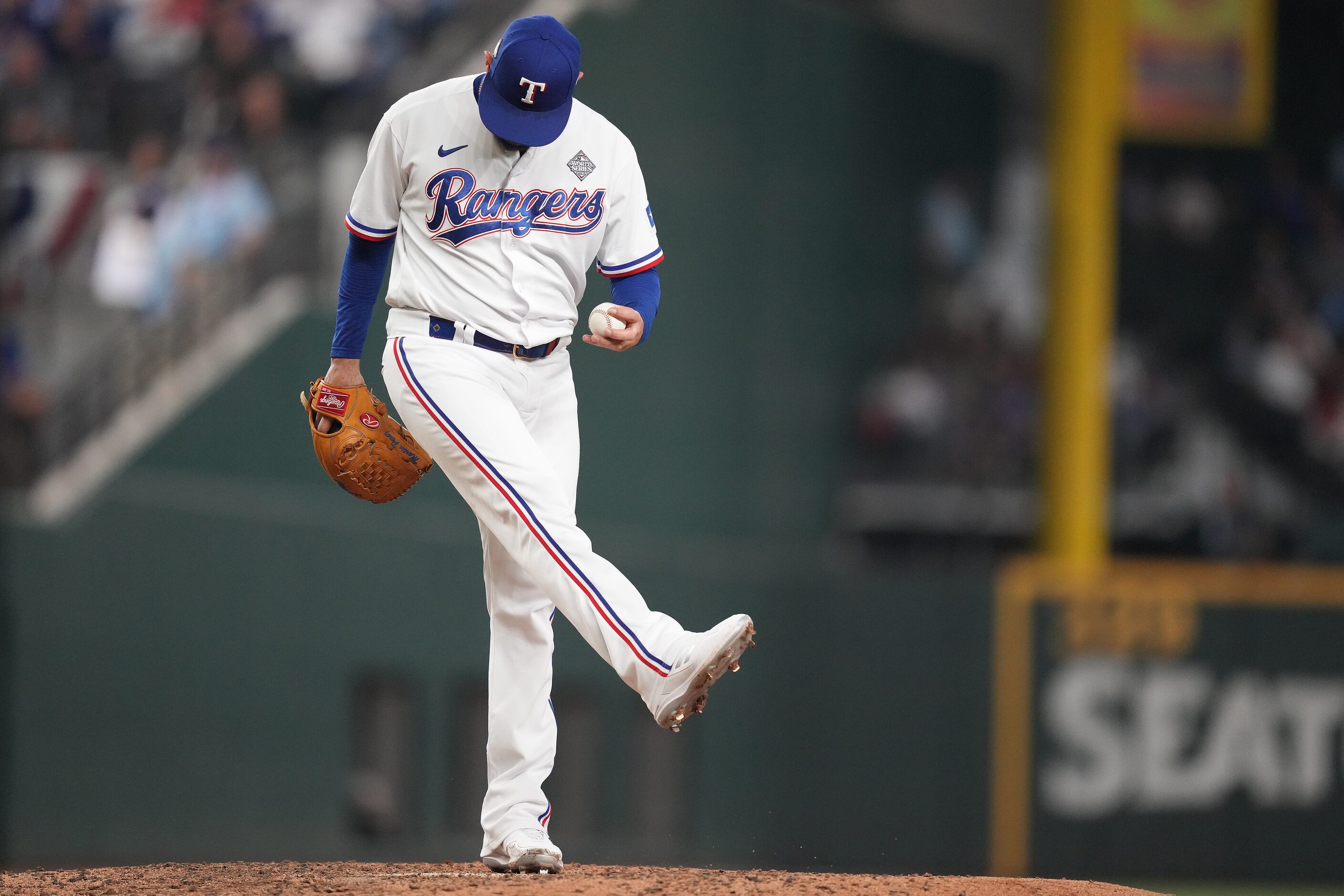 Texas Rangers pitcher Martin Perez kicks the dirt after giving up a leadoff single to...